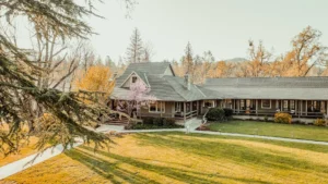 Expansive Great Lawn with Sierra Nevada mountain panorama at Sierra Sky Ranch 30-acre boutique hotel property near Yosemite National Park