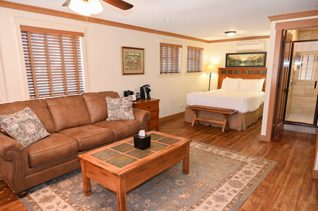 Spacious 335 sq ft Ranch House queen suite with warm pine furnishings at Sierra Sky Ranch near Yosemite sleeps up to 4 guests